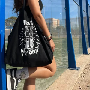 A Girl with a bag that says "This is my shit" and showing legs with rollerskates